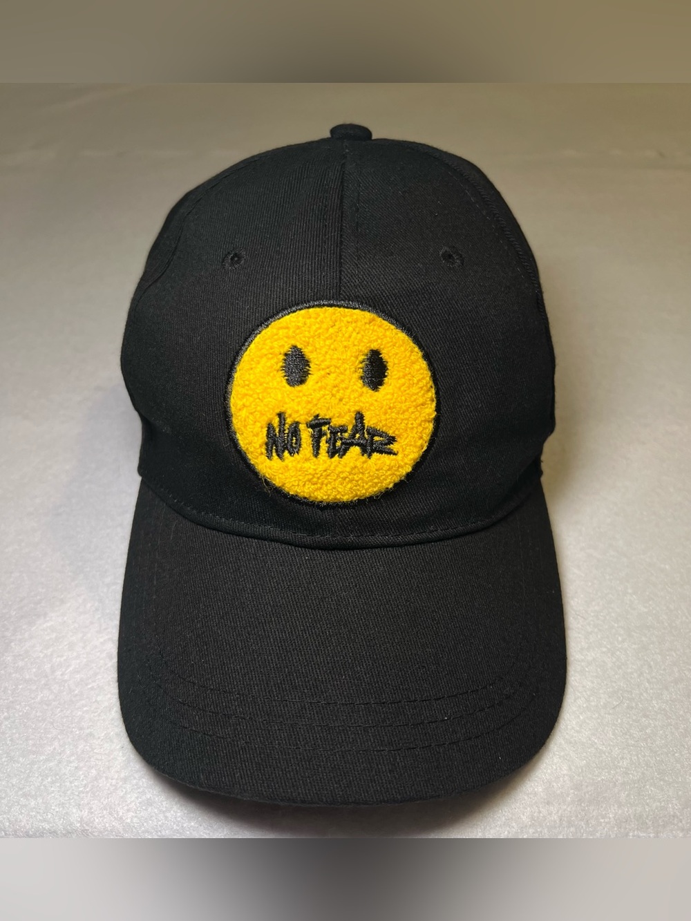 No Fear Men’s Smiley Face Chenille Patch Black Unstructured Snapback Hat Cap